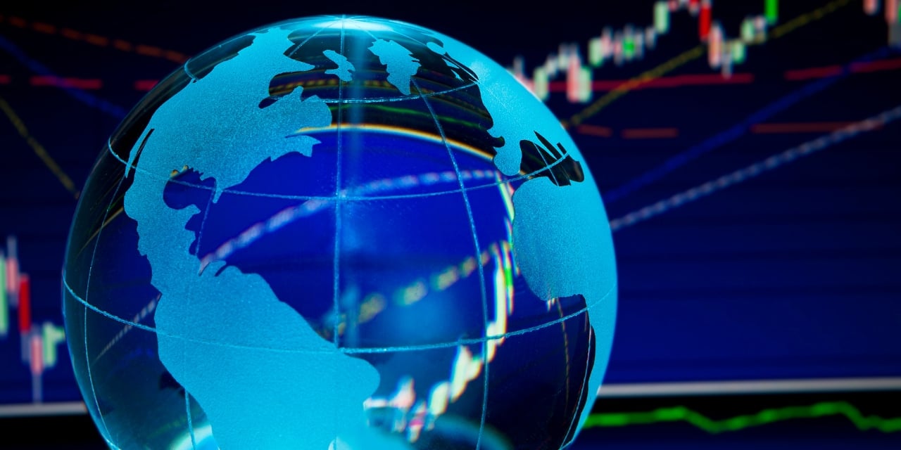Glass globe with financial graph image in the background.