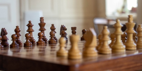 Wooden chess board and pieces.