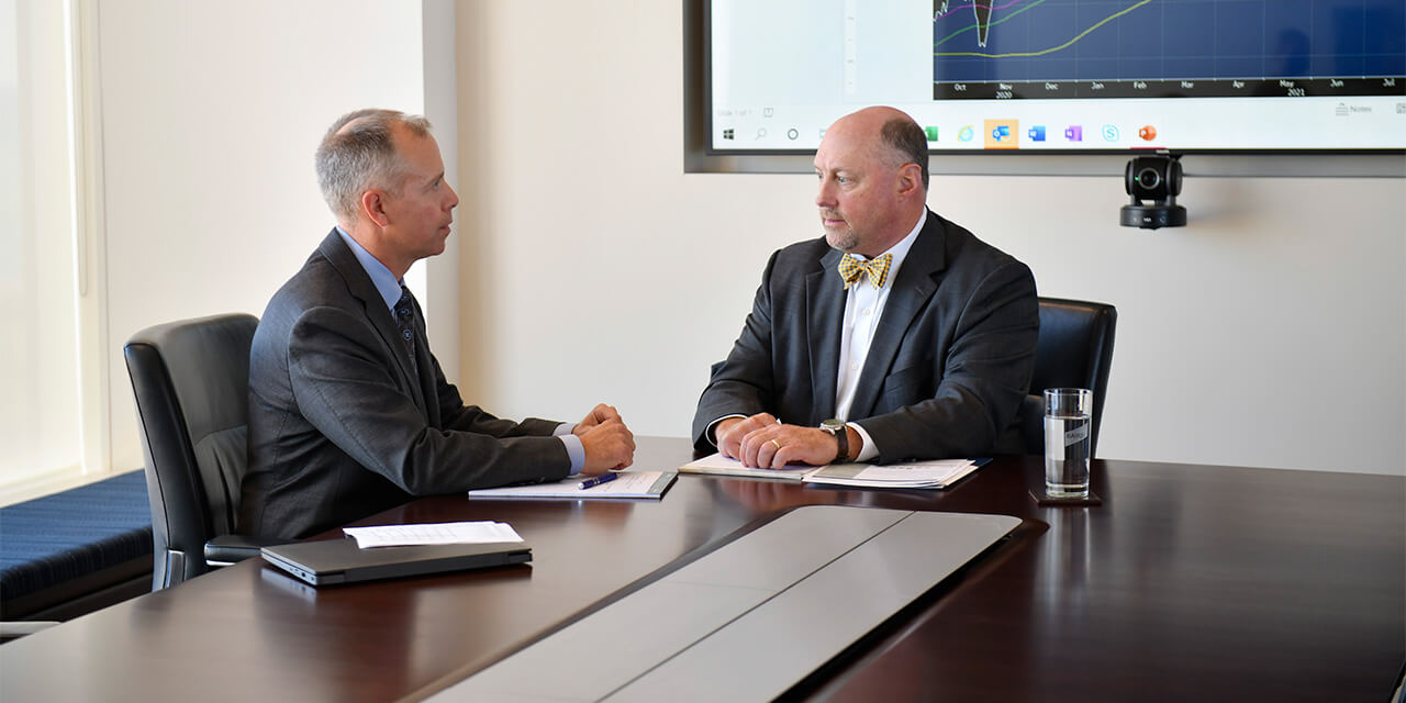 Two members of Baird's Equity Asset Management team discussing in a conference room