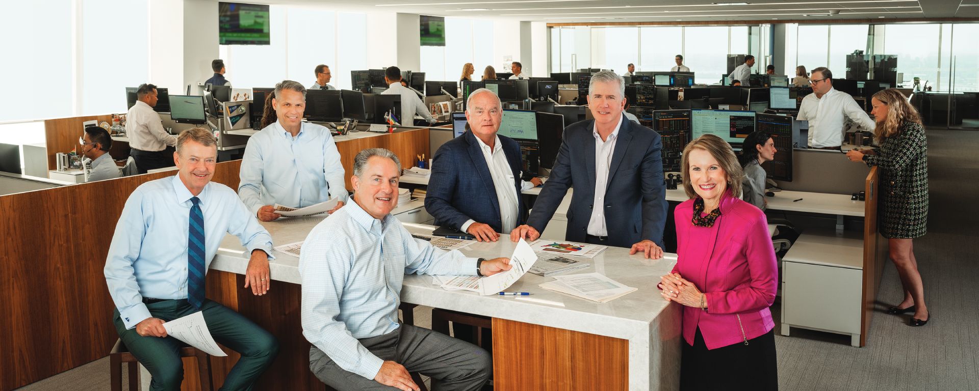 Baird Advisors Core Team posing around a table in an office in 2025.