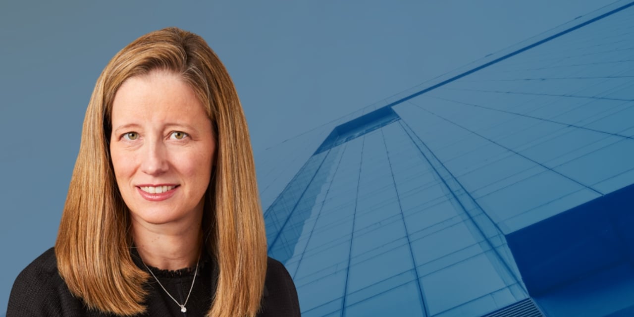 Meg Dean image laid over an image of a building with a blue overlay.