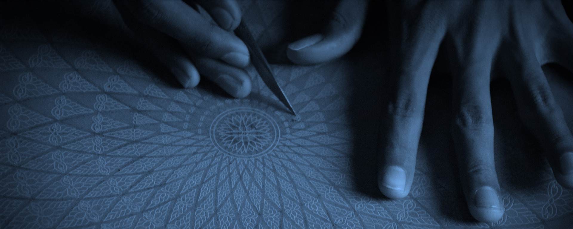 Photo of hands carving a pattern