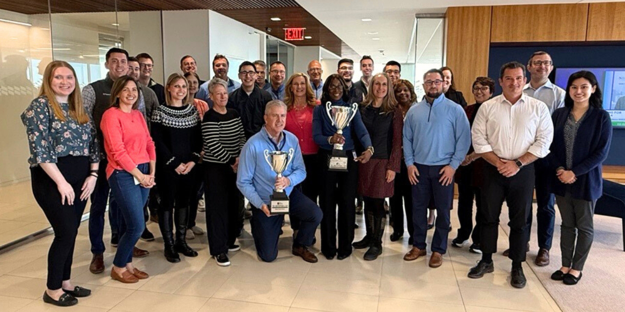 Baird Advisors associates holding trophies earned during the 2025 Unstoppable Cup